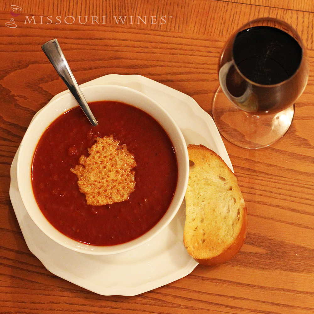 Bowl of tomato soup with a glass of Missouri Norton wine. 