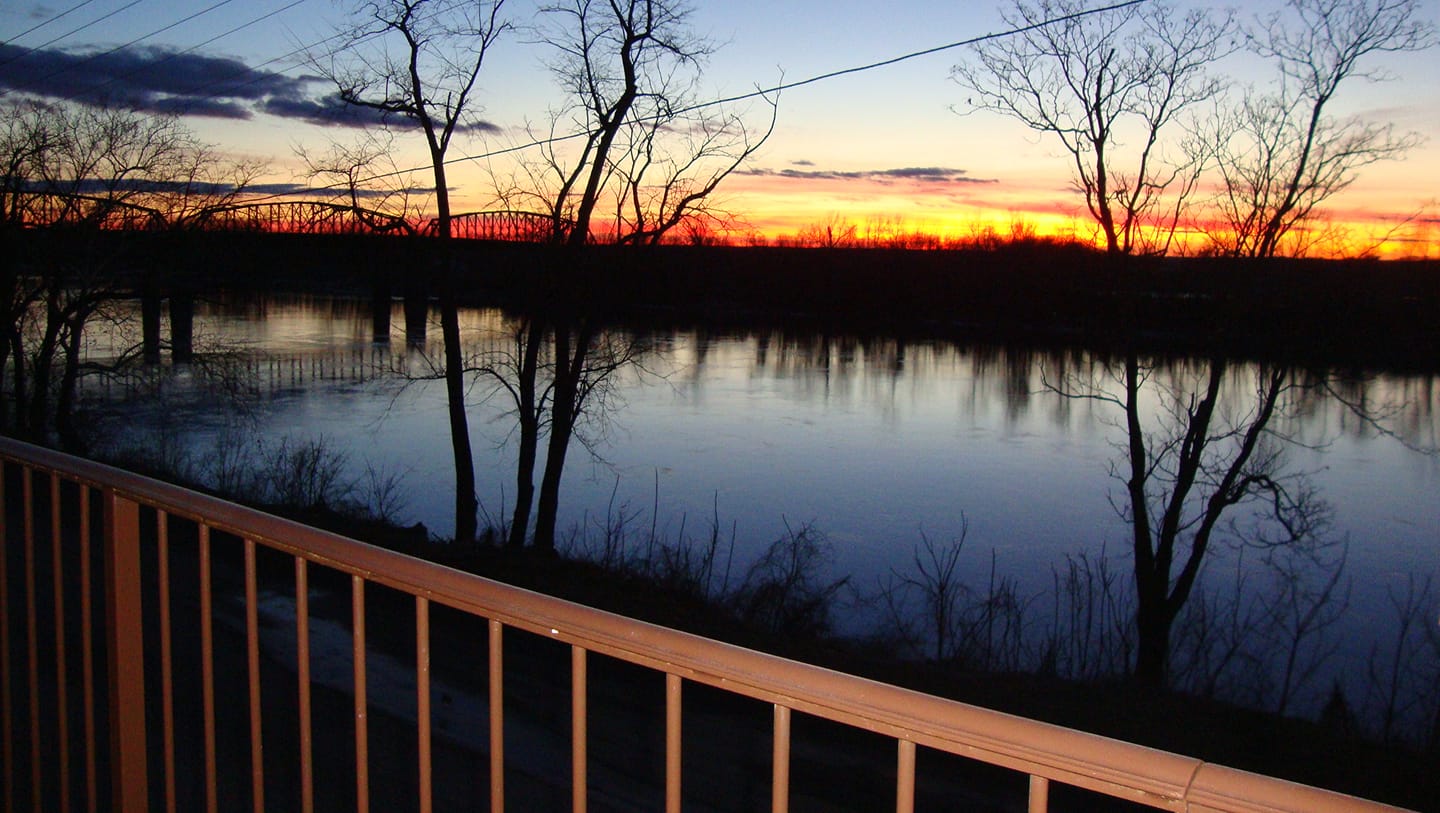 Beckett's Winery - outdoor photo, dusk, of a large pond with a sunset visible in the background.