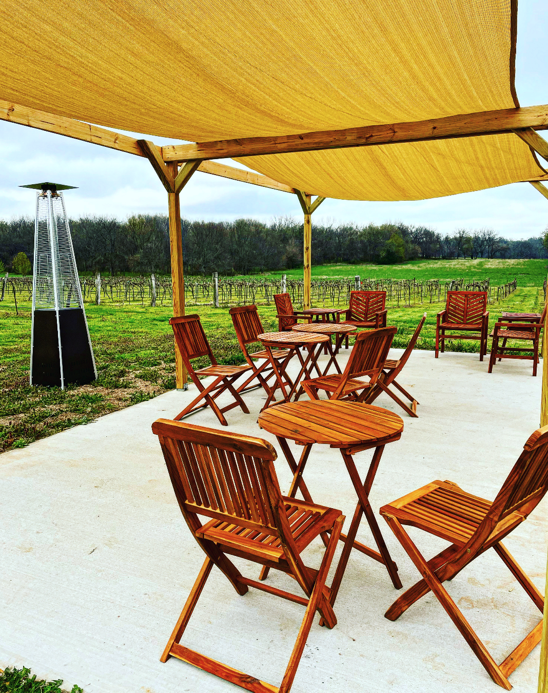 Pennington Wines- Outdoor seating with a heater under a canopy.