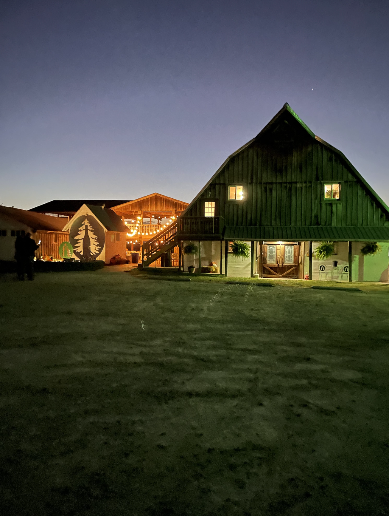 Prairie Barn Winery- The wooden barn style building lit up at night. 