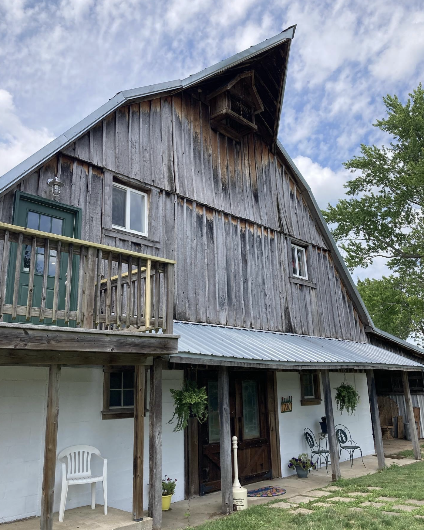 Prairie Barn Winery- A wooden barn style building with a deck and seating.