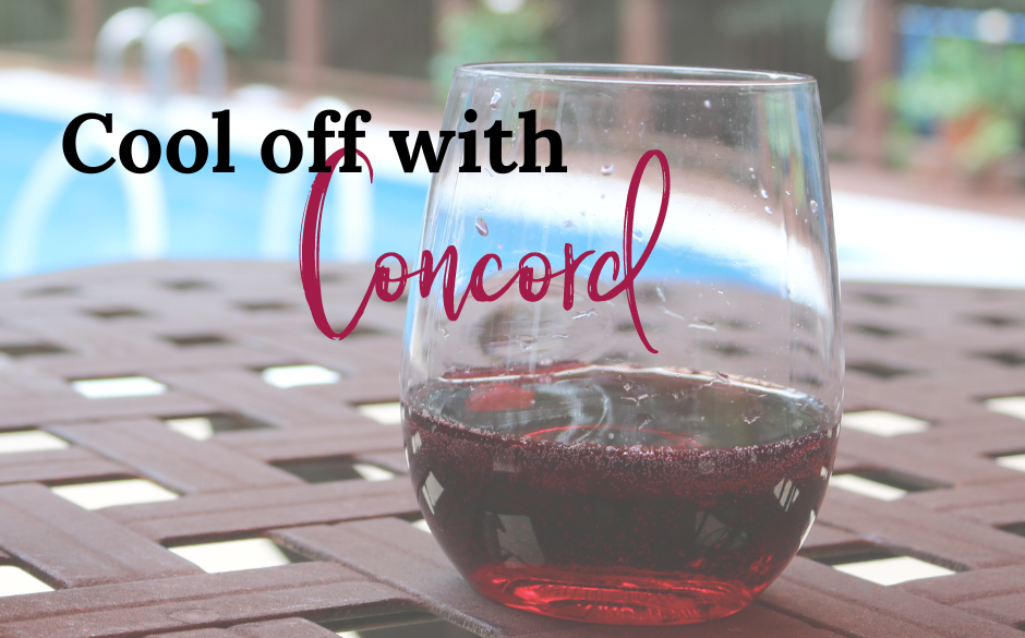 Glass of Concord next to the pool