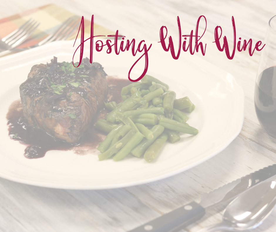 Plate with steak and green beans on it with silverware set along with a glass of wine