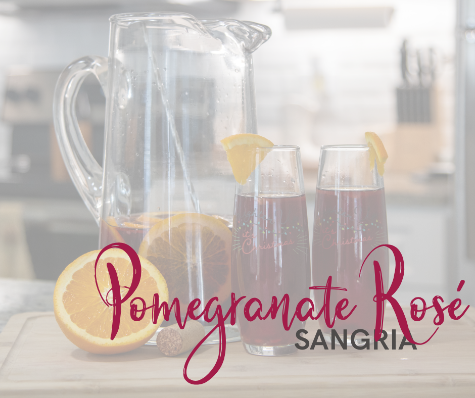 Glass pitcher half full of sangria. 2 glasses of sangria with orange slices on the rims. There is a half cut orange with a cork sitting in front of the pitcher. With text laid over the top of the photo. 