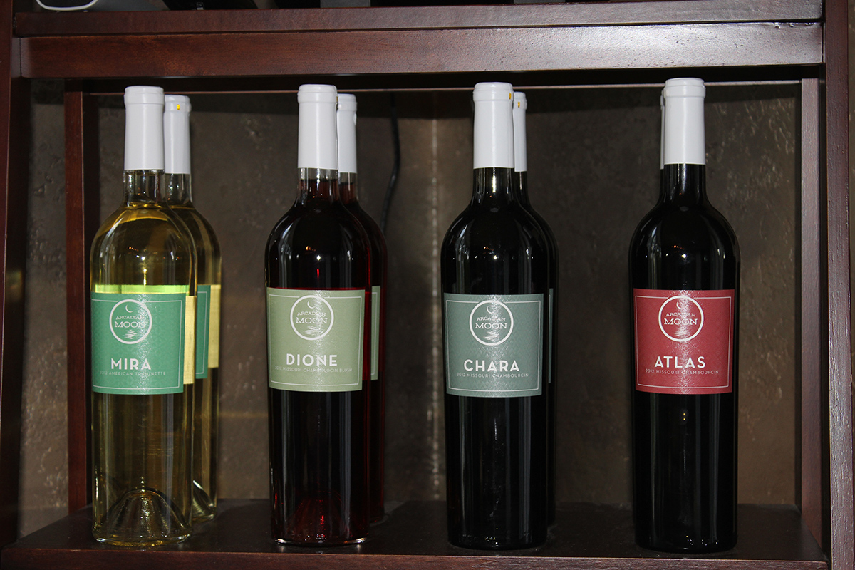 Arcadian Moon Winery & Brewery- Several bottle of red, rose, and white wine on a shelf.