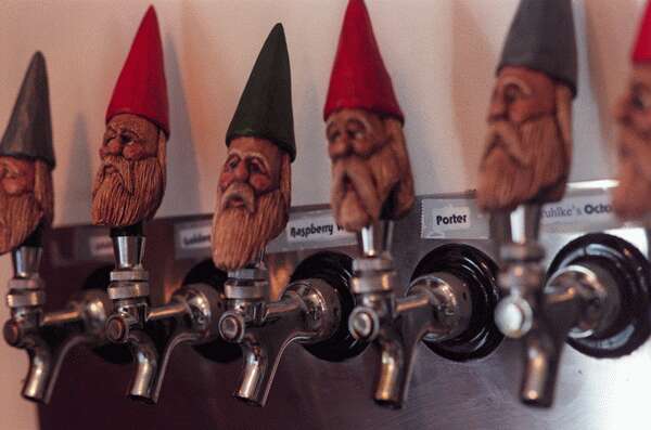 Bias Winery & Gruhlke's Microbrewery - indoor photo, a closeup of several beer serving taps which are topped with handles shaped like garden gnomes.