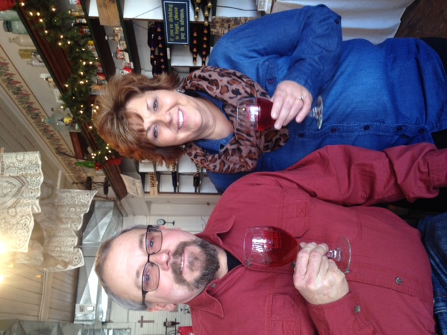 Hemman Winery- Winery owners together, each holding a glass of red wine.