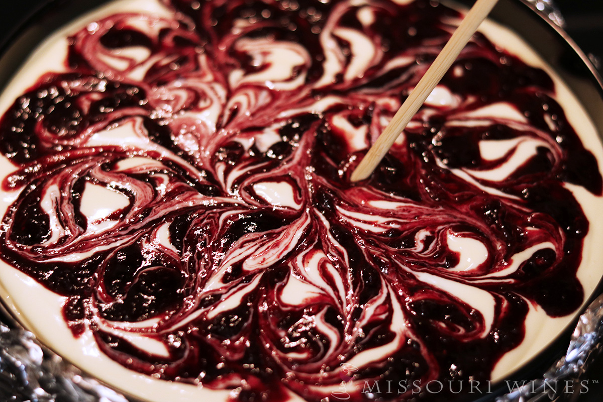 Mulled Wine Cheesecake: Swirling the sauce into the filling