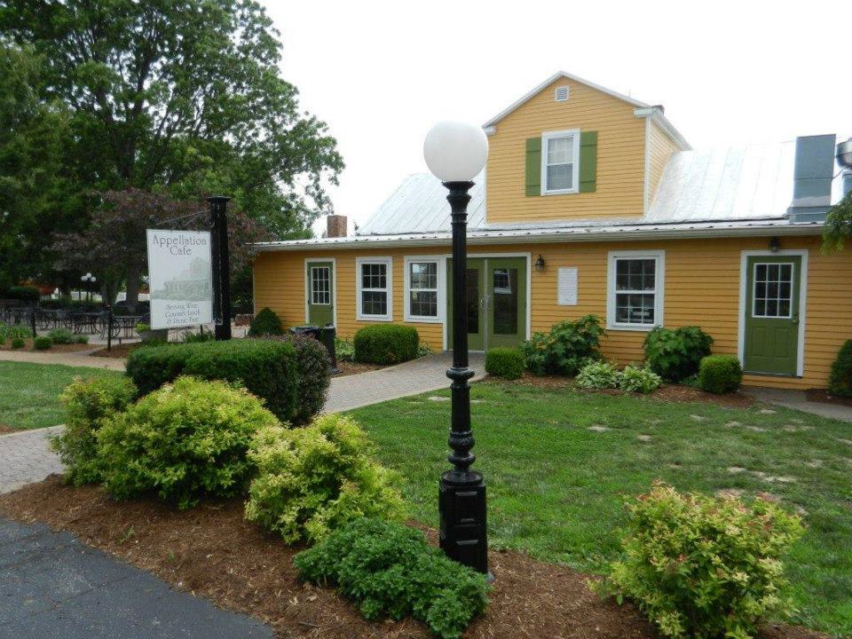 Mount Pleasant Estates- Yellow building with green accents and white trim.