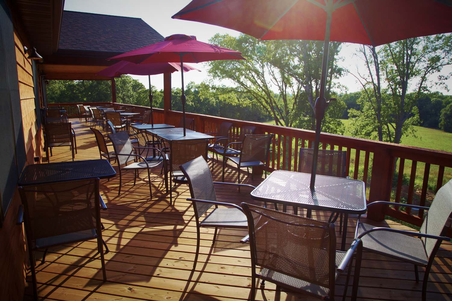 Peaceful Bend Vineyard- a large patio with several tables for outdoor seating