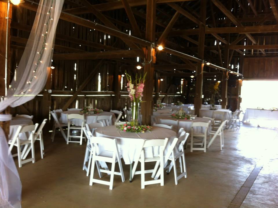 Riverwood Winery - indoor photo, daytime, of a large barn with tables decorated for a wedding.