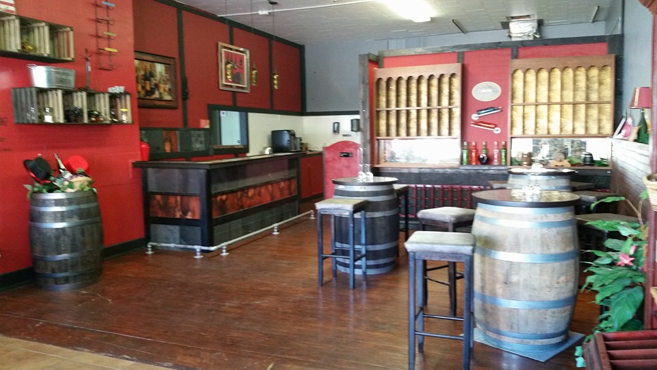 Top Hat Winery - indoor photo, daytime, of a bar and dining area. The walls are red and the floor is wood.