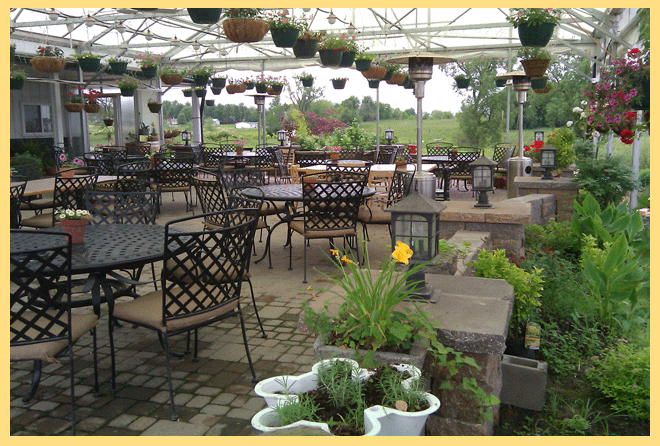 Van Till Family Farm Winery - outdoor photo, daytime, of a large space with patio seating and hanging plants surrounding the seating area.