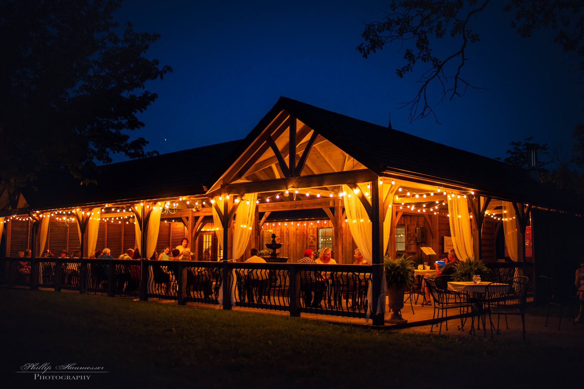 Viandel Vineyard- Outdoor shot of the venue patio in the late evening with string lights illuminating the seating.