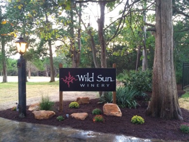 Wild Sun Winery- Outdoor sign for the winery that reads "Wild Sun Winery" with an image of a red sun.
