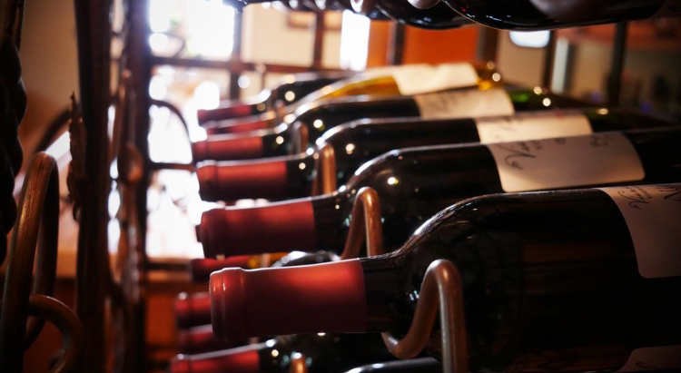 Viandel Vineyard- Six bottles of red wine on a wine rack.
