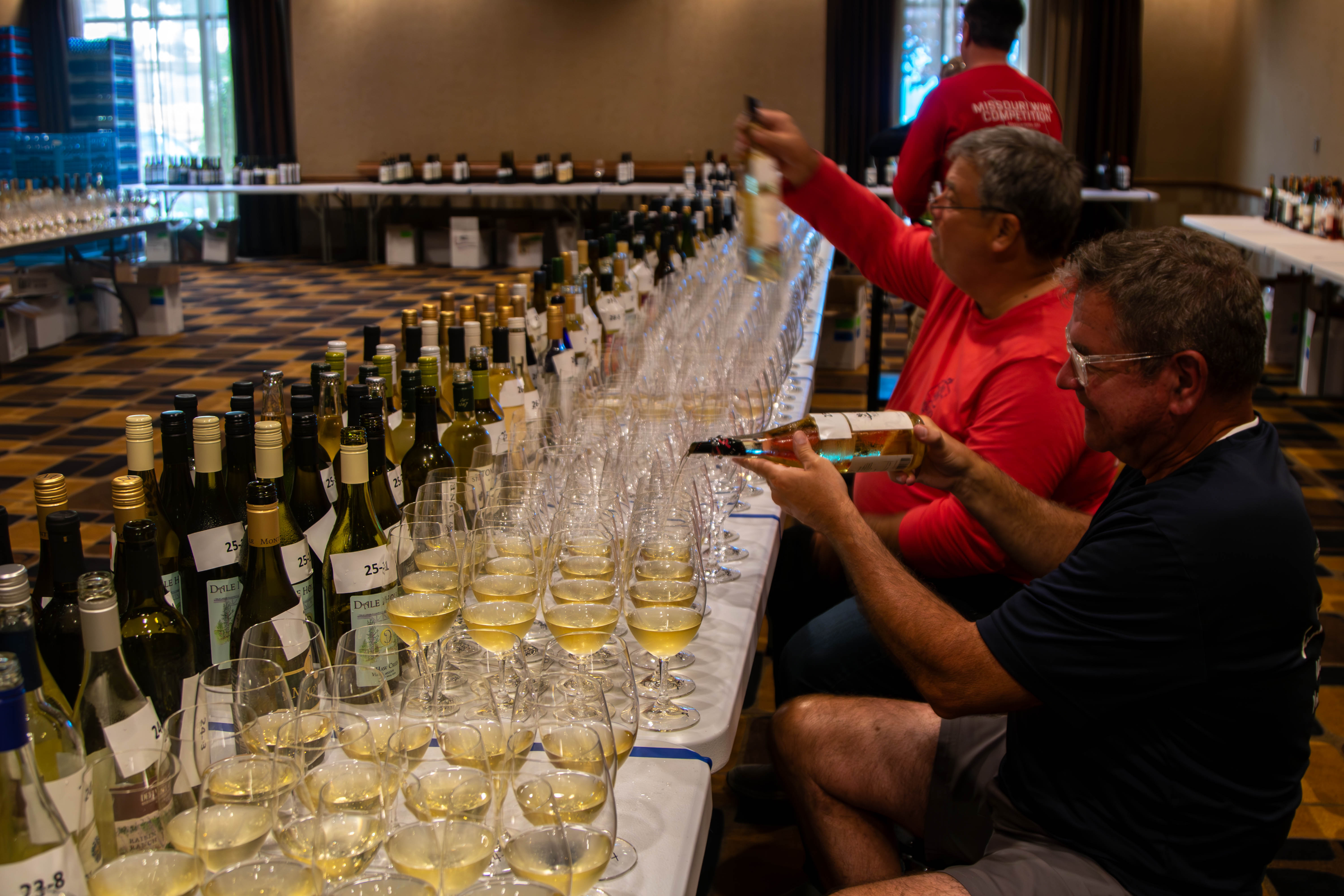 volunteers pouring wine