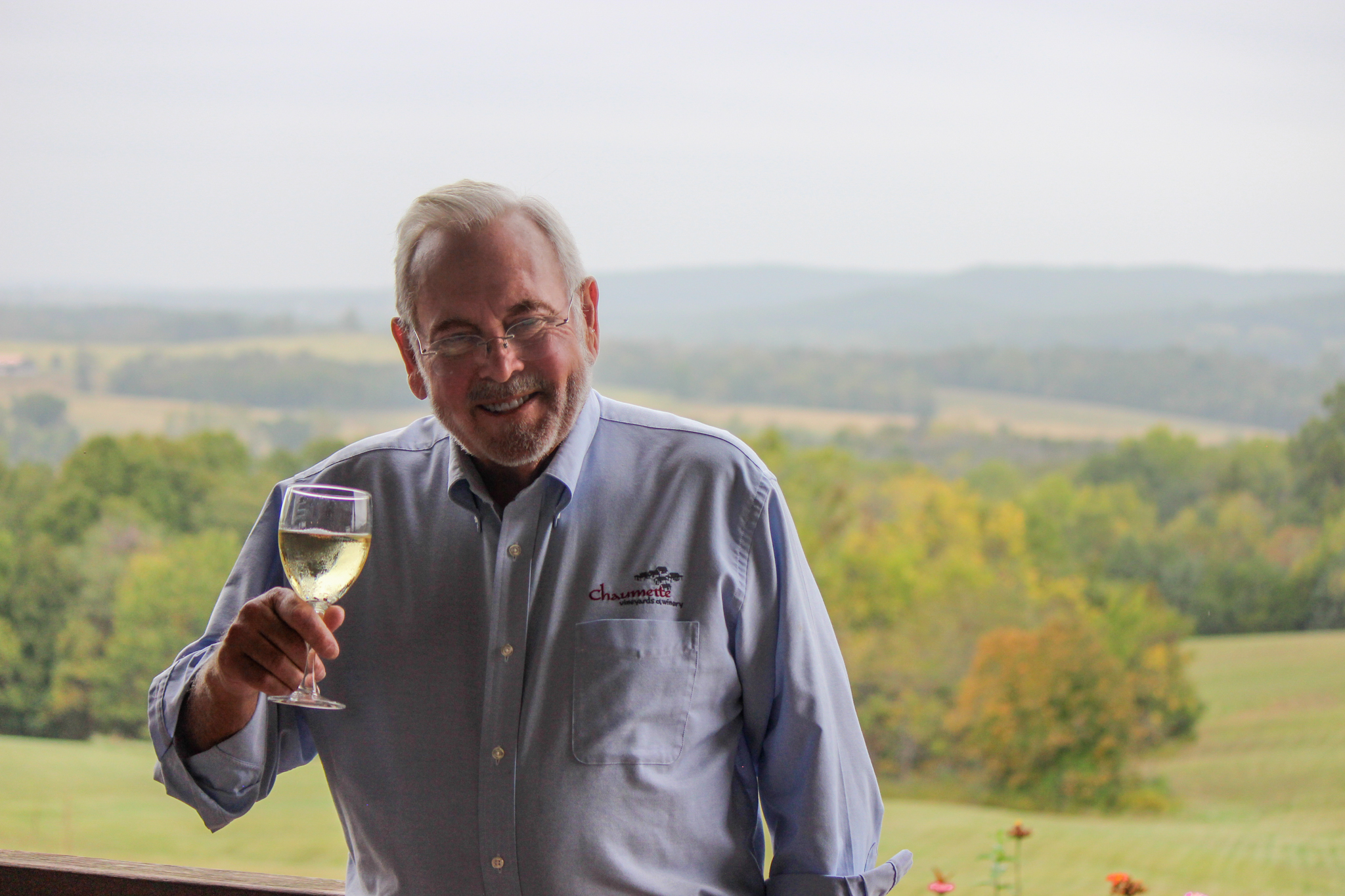 Hank Johnson smiling with a glass of wine