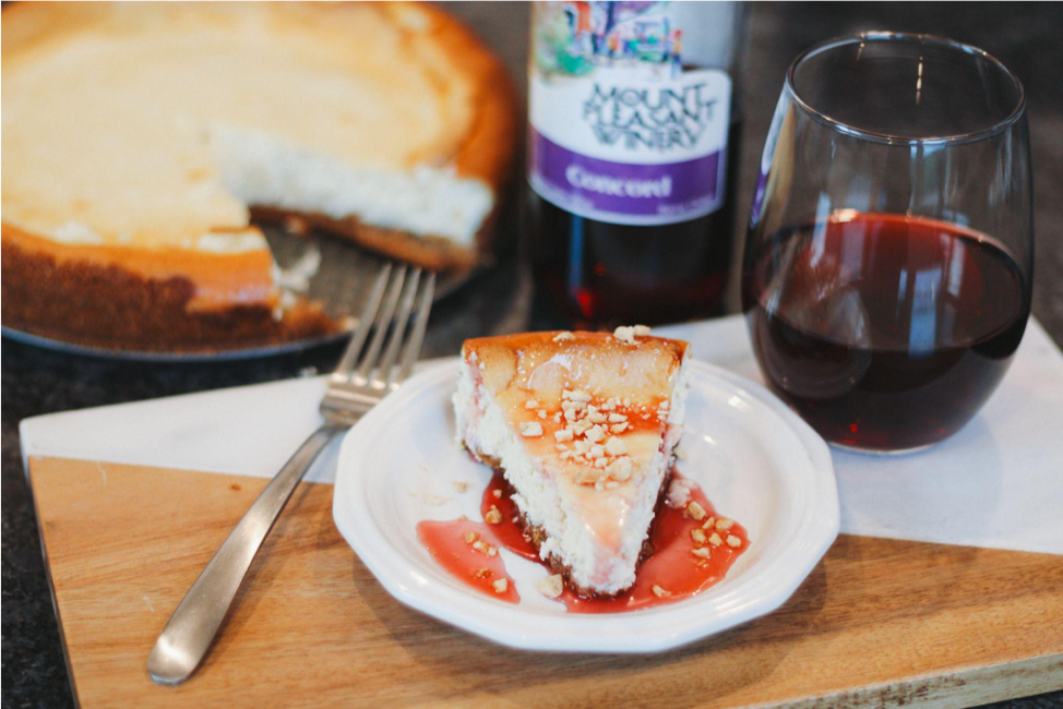 Slice of cheesecake with wine