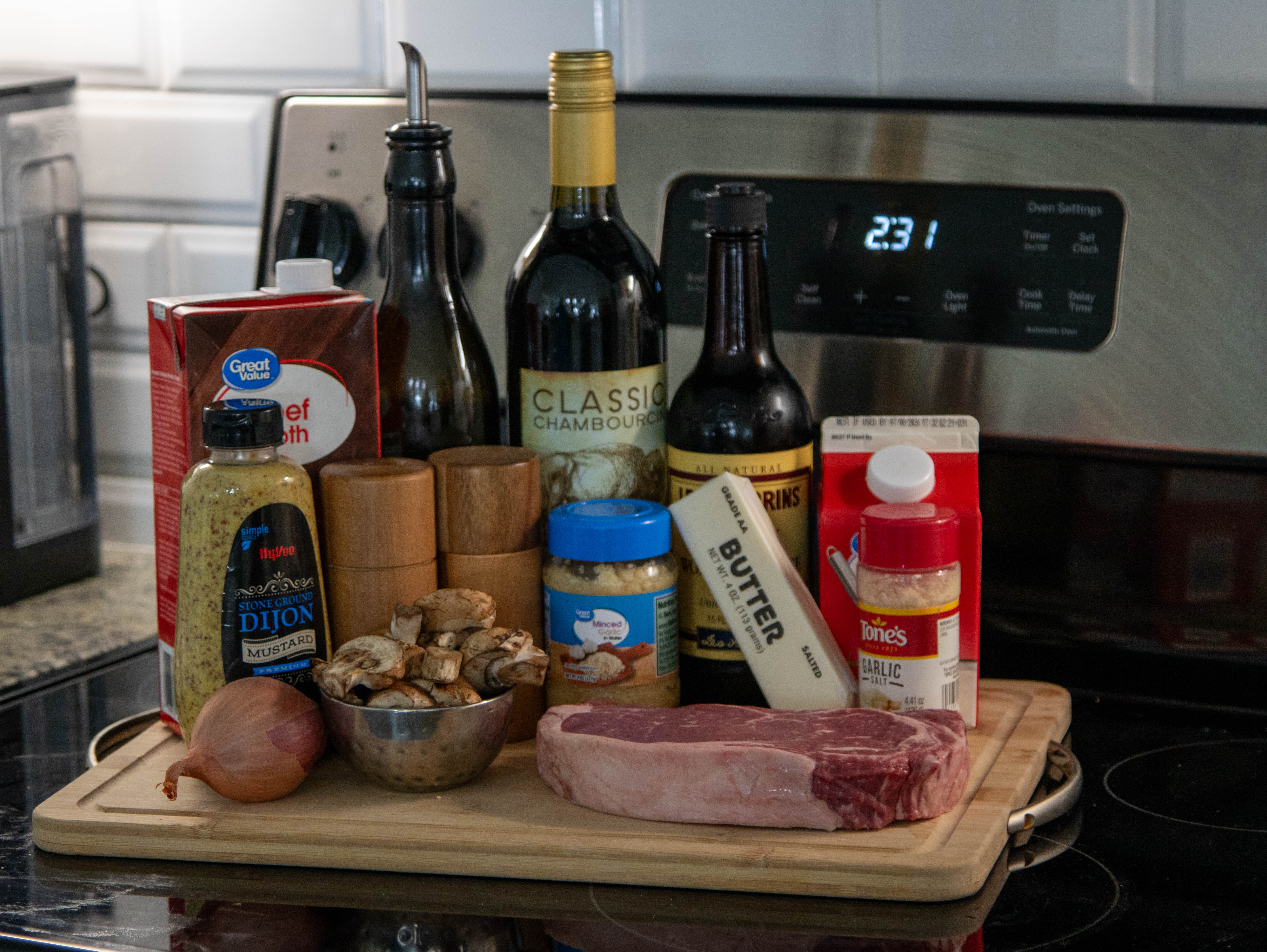 the ingredients stacked on a cutting board sitting on a stove