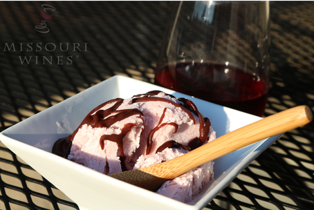 Ice cream in a bowl next to a wine glass