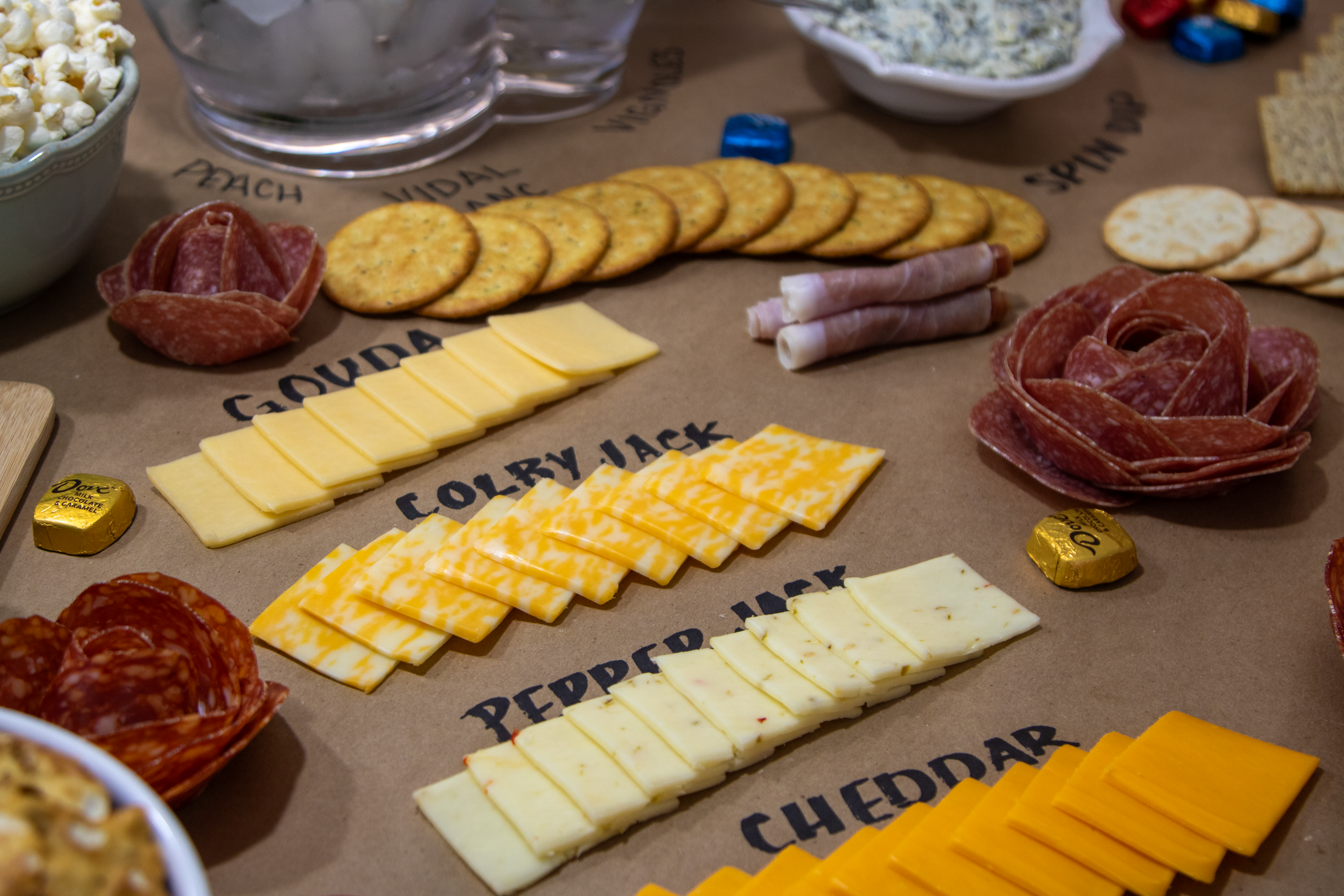 a close up shot of the snack board highlighting the different types of cheese offered 