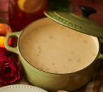 a pot of soup with the lid cracked on it