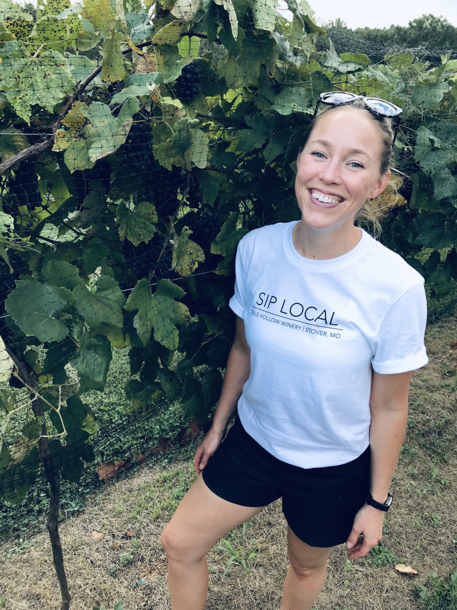 Photo of Katy Dale with grape vines