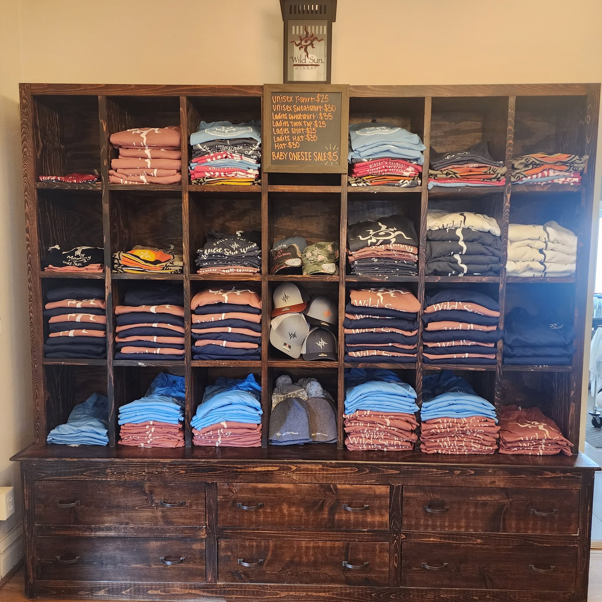 Wild sun winery t-shirts and hats on shelves 