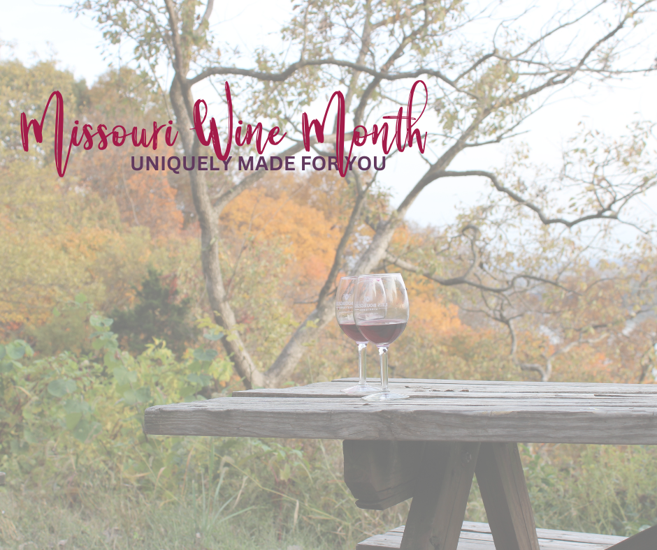 2 wine glasses sitting on a picnic table with a fall background