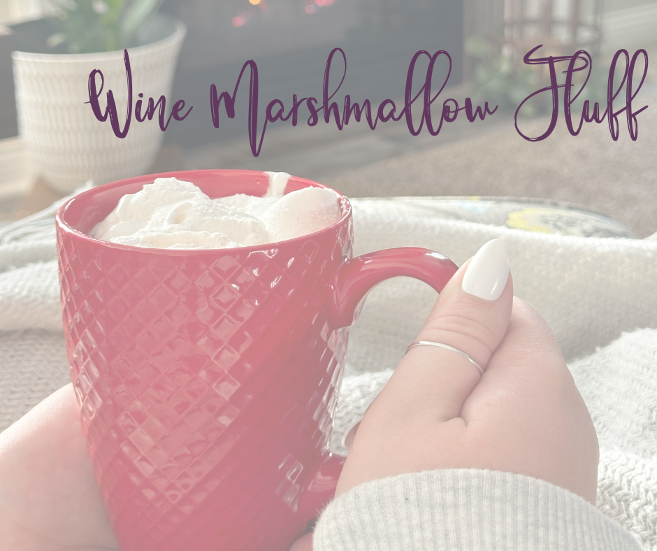 Hand holding cup of hot chocolate with wine marshmallow fluff with text overlayed