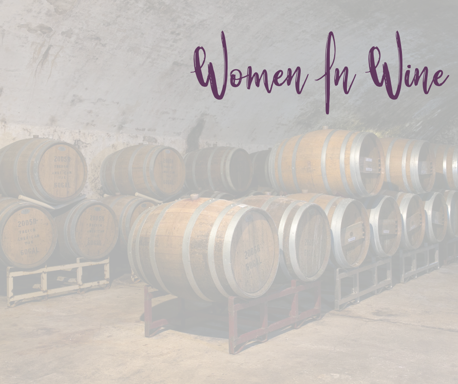 Barrels stacked in a cellar with words on the top reading Women In Wine