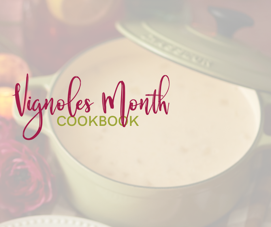 a pot of soup with the lid cracked on it with the words vignoles month cookbook on the top