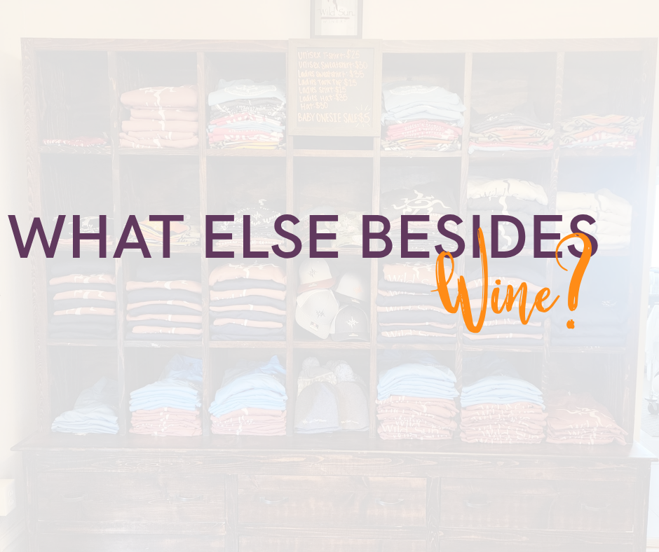 Shirts folded in shelves with the words what else besides wine?